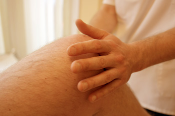 An osteopath manipulating a knee